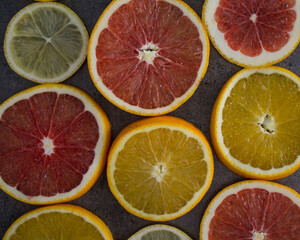 Background made of ripe juicy oranges slices. Top view photo of different types of citrus. 