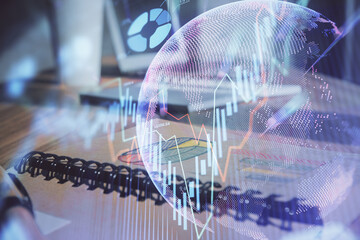 Double exposure of financial graph drawings and desk with open notebook background. Concept of forex market