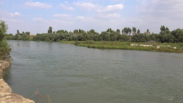 Large riverbed surrounded by soil and trees in flat plain.Panoramic cute plain lowland large big slow flow water color summer firat dicle etigris tigris nature mesopotamia olga volga danube uphrates.