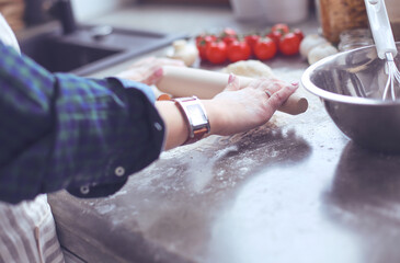 Fototapeta premium Beautiful woman cooking cake in kitchen standing near desk.