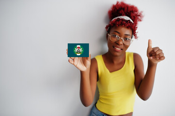 African woman with afro hair hold Yobe flag isolated on white background, show thumb up. States of Nigeria concept.