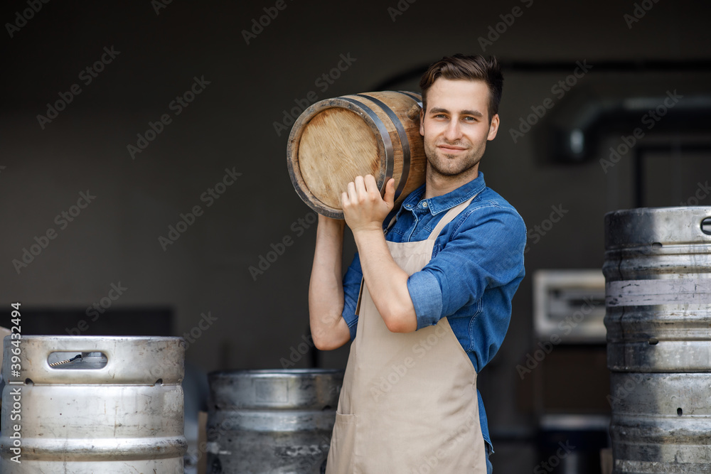 Wall mural Strong handsome male brewery worker and industrial production