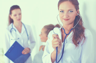 Woman doctor with folder standing at hospital