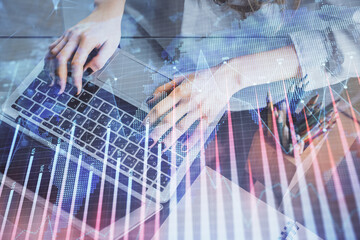 Double exposure of woman hands typing on computer and forex chart hologram drawing. Stock market invest concept.