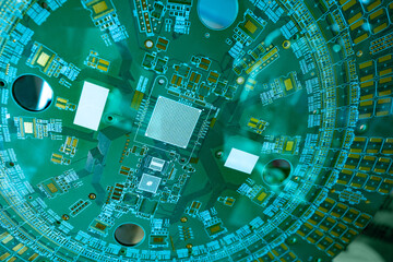 Round printed circuit Board. Electronic circuit of the computer. Production of printed circuit boards. Radionics background. The microchips are soldered to a circular PCB.