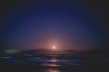 Naklejka na ściany i meble Beautiful full moon over the sea in a night with stars