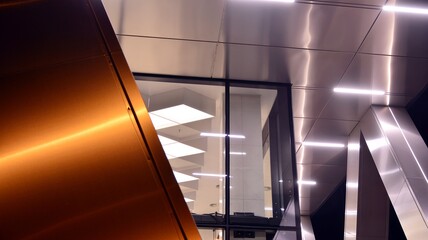 Combination of metal and glass wall material. Steel facade on columns. Abstract modern architecture. High-tech minimalist office building. Contemporary business architecture abstract fragment in night