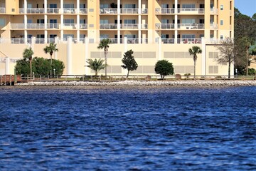 Santa Rose Island, Florida, USA - September 2020. A wonderful view with palm trees to the multi-storey hotel.