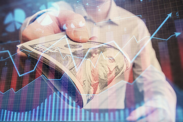 Multi exposure of financial graph drawing hologram and USA dollars bills and man hands. Analysis concept.