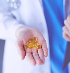 Close-up shot of doctor's hands holding pills at clinic.