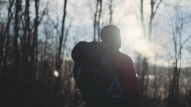 Mature Man With Backpack In Winter Landscape