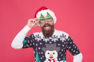 santa guy in hat and party glasses like his favorite winter sweater having fun on new year holiday, winter holiday