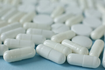 White pills on blue background