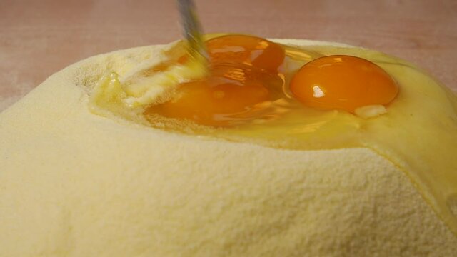 The egg and semolina are mixed with a fork