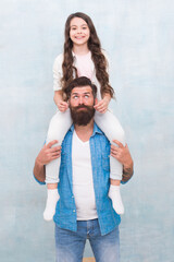 Growing mustache is fun. Little daughter twist fathers moustache. Happy family grey background. Bearded man ride child on shoulders. Family values. Trust relationship. Love and care