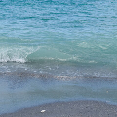 turquoise wave crashing on the beach