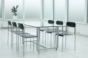 Black chairs glass table in office space