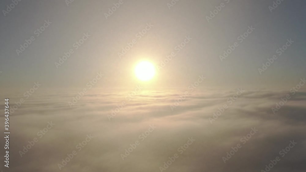 Wall mural aerial camera diving into the thick clouds clouds