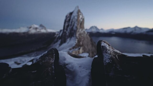 Hiker Resting With Segla Mountain In Norway