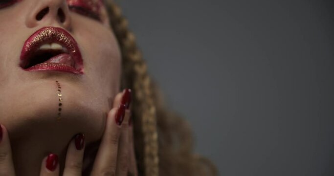 Fashion and beauty, model with red makeup and nail polish is posing, close up 4k