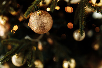 Obraz na płótnie Canvas Close up of ball on Christmas tree with decoration and garland, under which a lot of presents. Prepare to winter holidays, New Year background concept