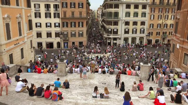 Crowded Spanish Steps Piazza di Spagna in Rome Italy.Piazza di Spagna, at the bottom of the Spanish Steps, is one of the most famous squares in Rome Italy. It owes its name to the Palazzo di Spagna 4K
