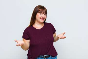 overweight woman looking happy, arrogant, proud and self satisfied, feeling like a number one