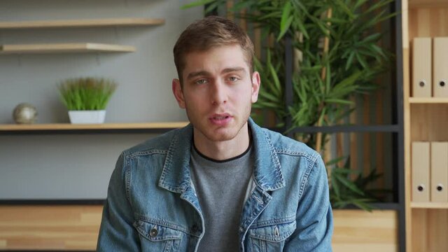 Businessman communication online looking at camera from home office. Entrepreneur conducting corporate video conference through webcam