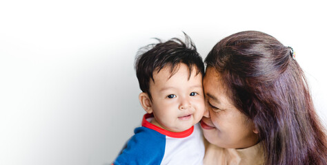 Happy loving family.Indian Grandmother and grandson are having a good time together and playing peekaboo and kiss her grandson at home.Grandson is smiling and laughing with his grandmother.Kid boy.