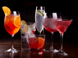 cocktail collection on wooden table on dark background