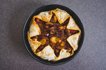 plant-based food, vegan pie with mediterranean vegetables potato and olive red pesto