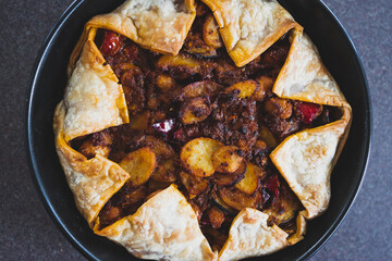 plant-based food, vegan pie with mediterranean vegetables potato and olive red pesto