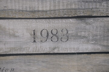 wooden texture of three planks with number 1983 embrassed on it