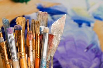 Row of artist paint brushes on background