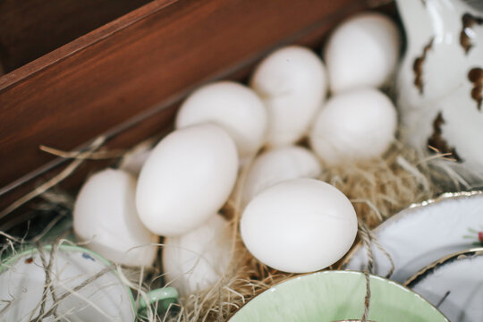 Duck eggs in a nest of hay. Natural nest basket. Close-up, Selective focus. Healthy food concept.