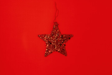 Fototapeta na wymiar flat lay with star shaped christmas toy on red background