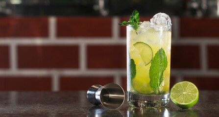 Summer refreshing yellow alcohol and lemonade cocktail with mint and ice, ideal for celebrations