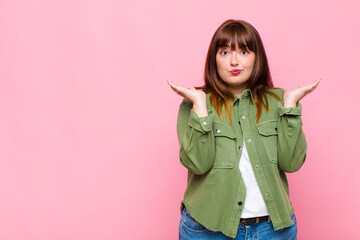 overweight woman feeling puzzled and confused, doubting, weighting or choosing different options...