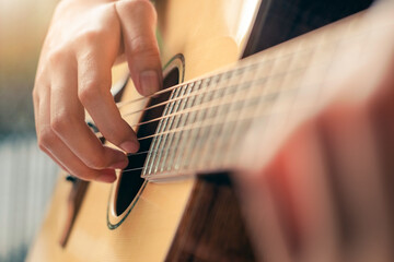 Fototapeta premium Close up of man hand playing guitar.