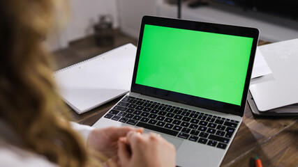 Laptop with green screen display close up shot - home shooting