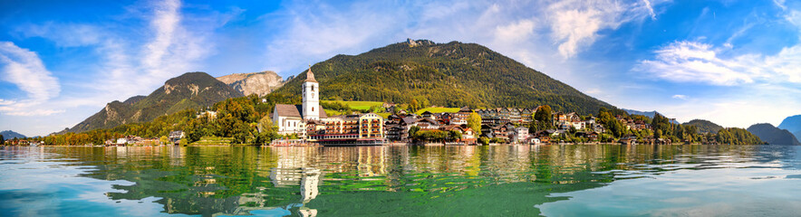 Panoramic view from the Wolfgangsee to the village St. Wolfgang with the mountains in the background