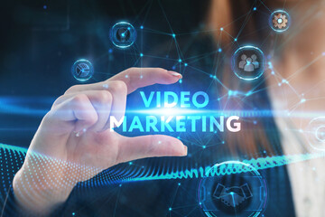 Business, Technology, Internet and network concept. Young businessman working on a virtual screen of the future and sees the inscription: Video marketing