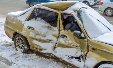 A broken car after a winter accident on the street.