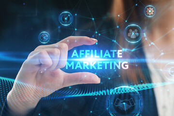 Business, Technology, Internet and network concept. Young businessman working on a virtual screen of the future and sees the inscription: Affiliate marketing