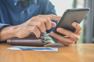 Close up hand holding mobile phone shopping online with credit card soft focus
