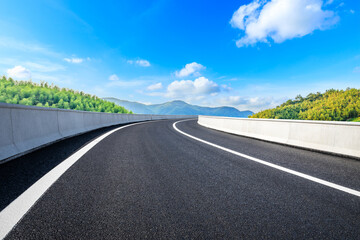 Asphalt road and green mountain with bamboo forest natural landscape.