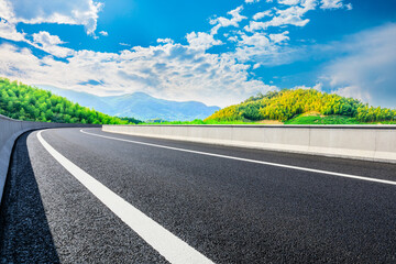 Fototapeta premium Asphalt road and green mountain with bamboo forest natural landscape.