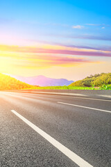 Country asphalt road and green tea plantation with bamboo forest natural landscape.