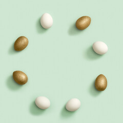 Easter round frame from painted chicken eggs, shiny golden colored and white eggs on green paper background. Easter Flat lay
