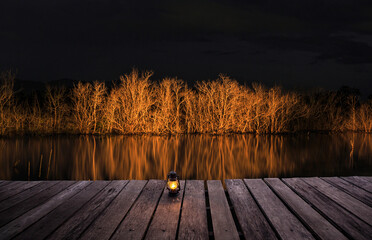 Lanterns and wooden walkways in the swamp in the evening.